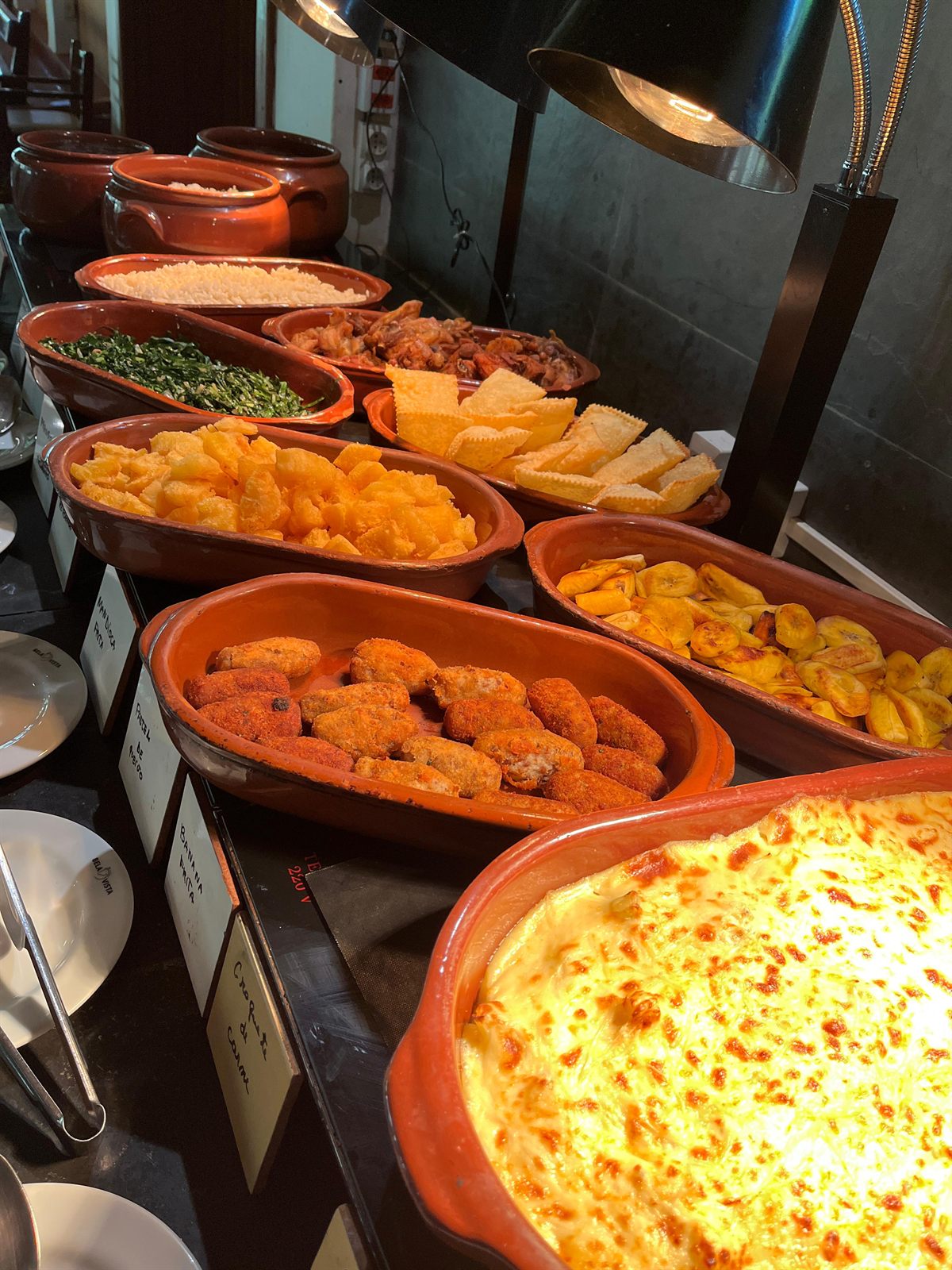 Bufê de comida caseira em travessas de barro